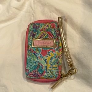 Lilly Pulitzer wristlet, pink, blue, and yellow traveller pattern. Gold strap.